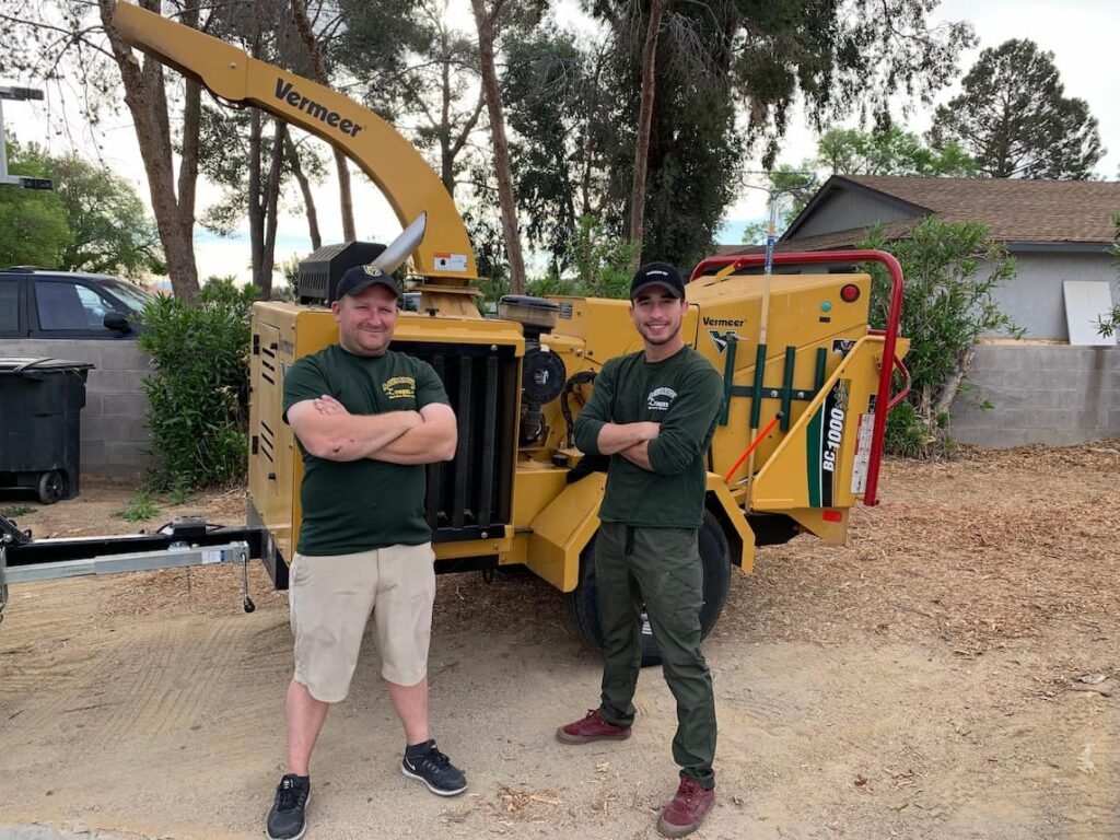 A cut above tree service team standing infront of chipping in las vegas home
